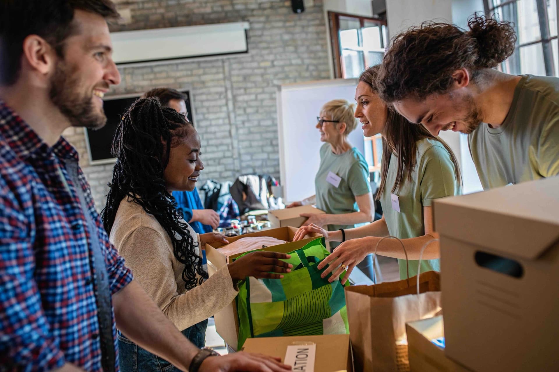 Volunteers packing donations together at a community center