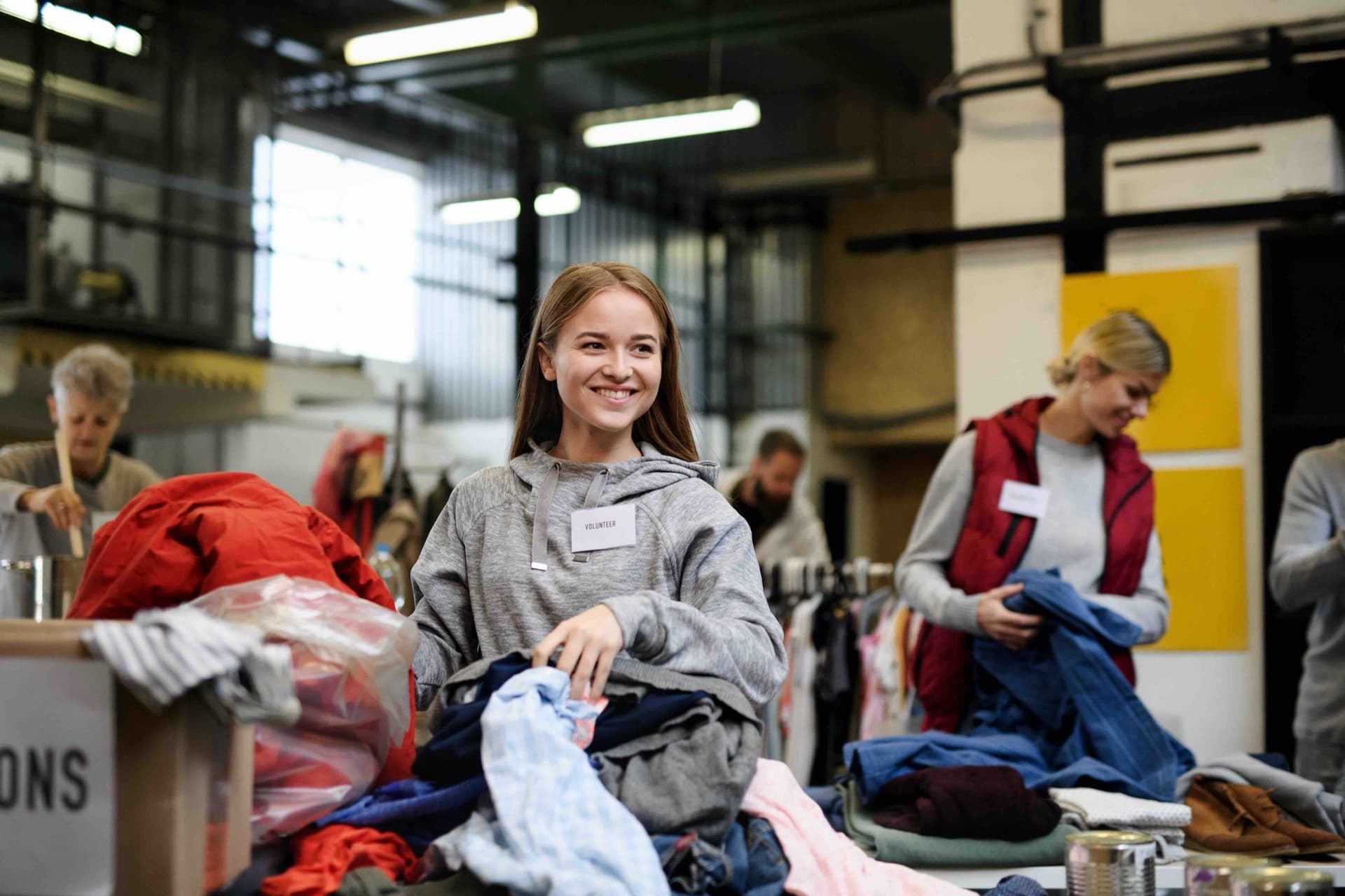 A volunteer sorting donations at a community drive